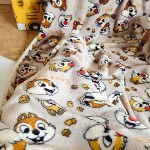 Plaid Disney avec motifs de Tic et Tac sur un lit